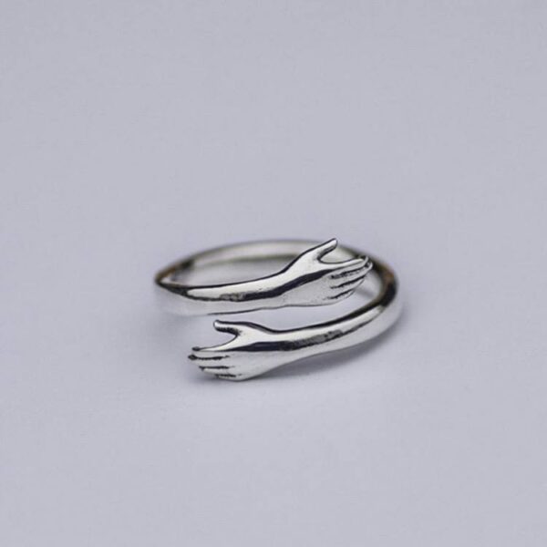 Каблучка жіноча металева «Рученята обіймають» срібний (7460)